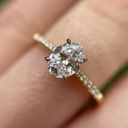 18ct yellow gold and oval white diamond engagement ring with diamond-set shoulders