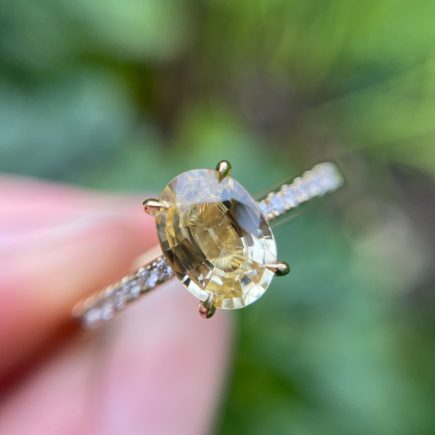 18ct yellow gold and oval yellow sapphire engagement ring with diamond-set shoulders
