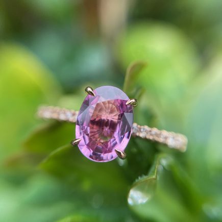 18c rose gold and oval pink sapphire engagement ring with diamond-set shoulders