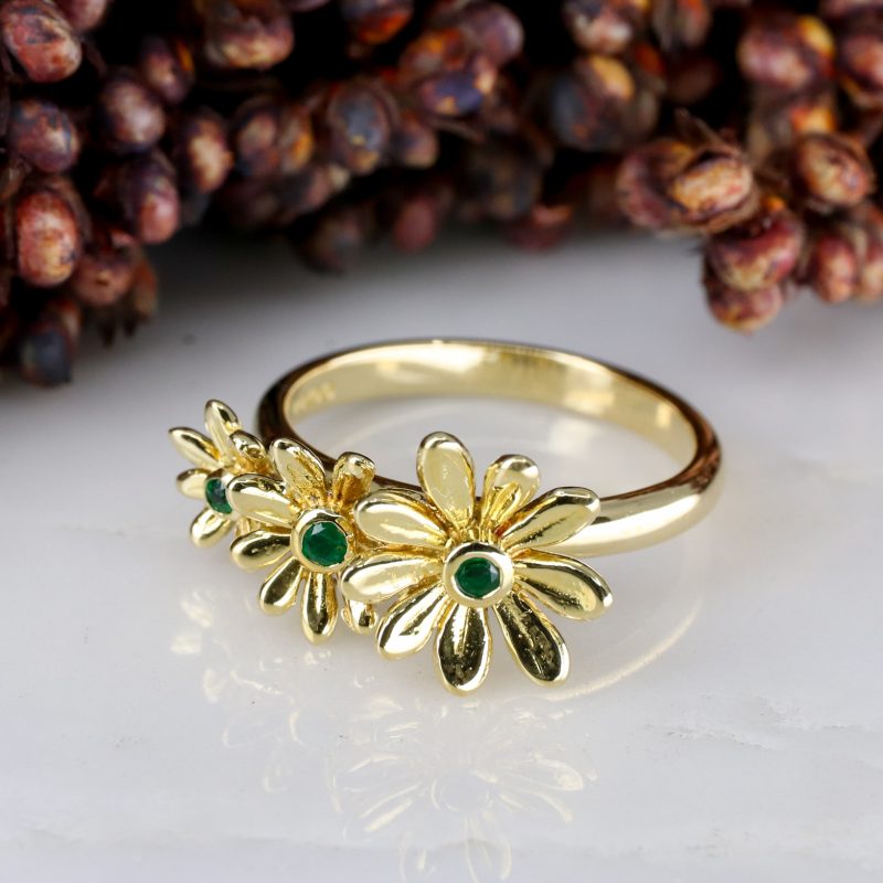 18ct yellow gold and emerald daisy trilogy ring