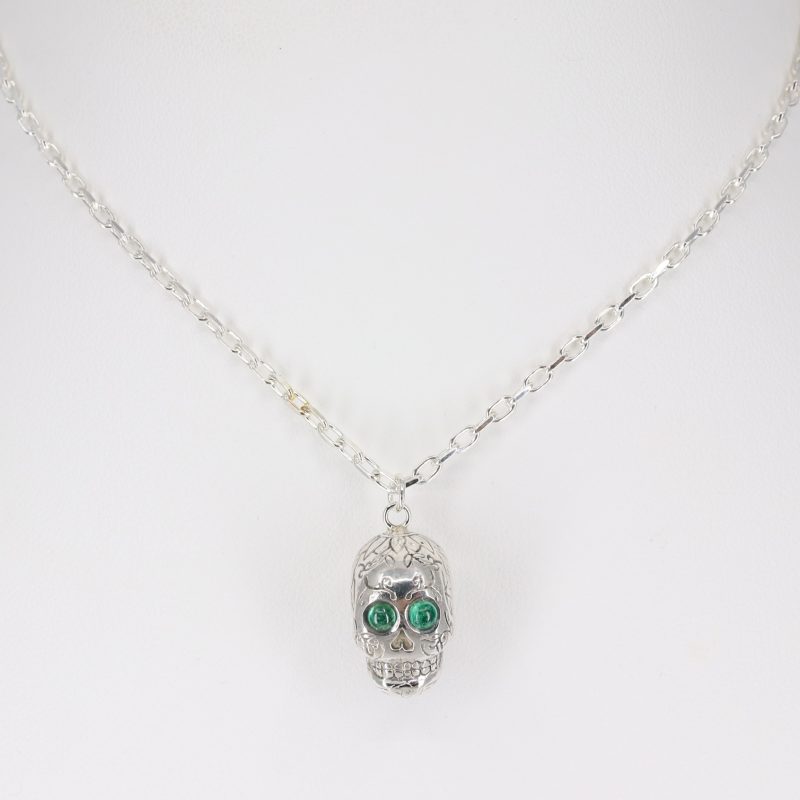 Silver sugar skull pendant set with cabachon emerald eyes