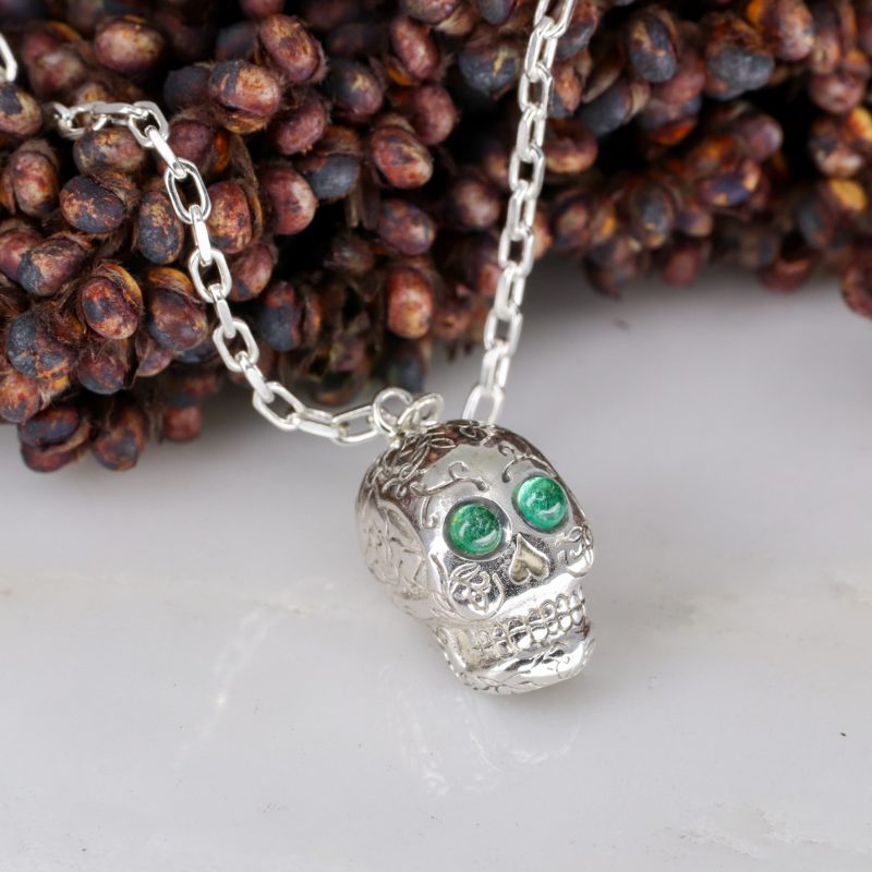 Silver sugar skull pendant set with cabachon emerald eyes