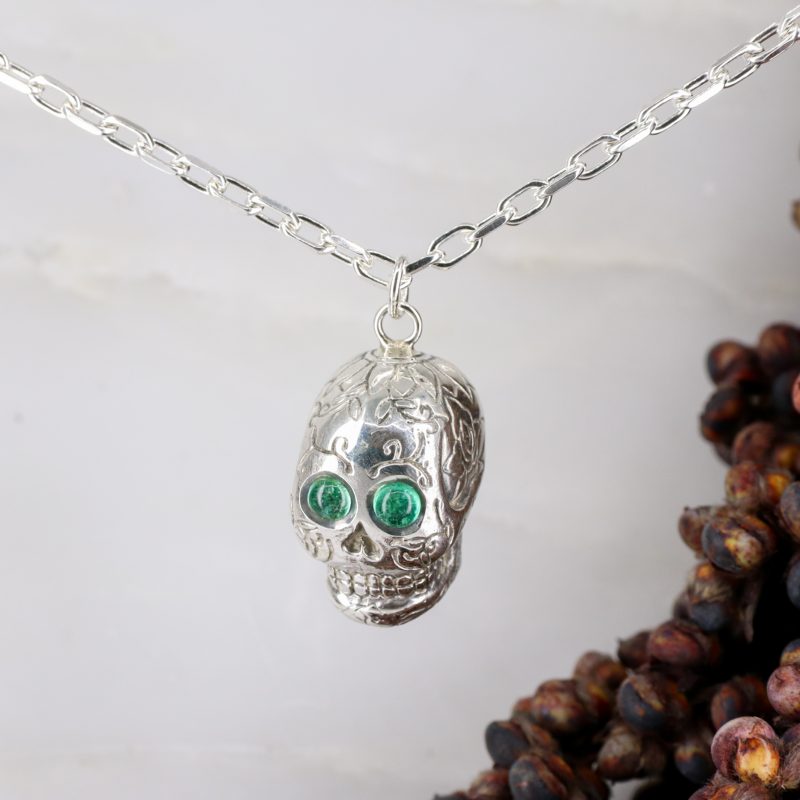 Silver sugar skull pendant set with cabachon emerald eyes