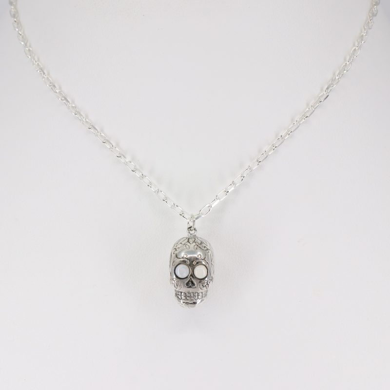 Silver sugar skull pendant set with opal eyes