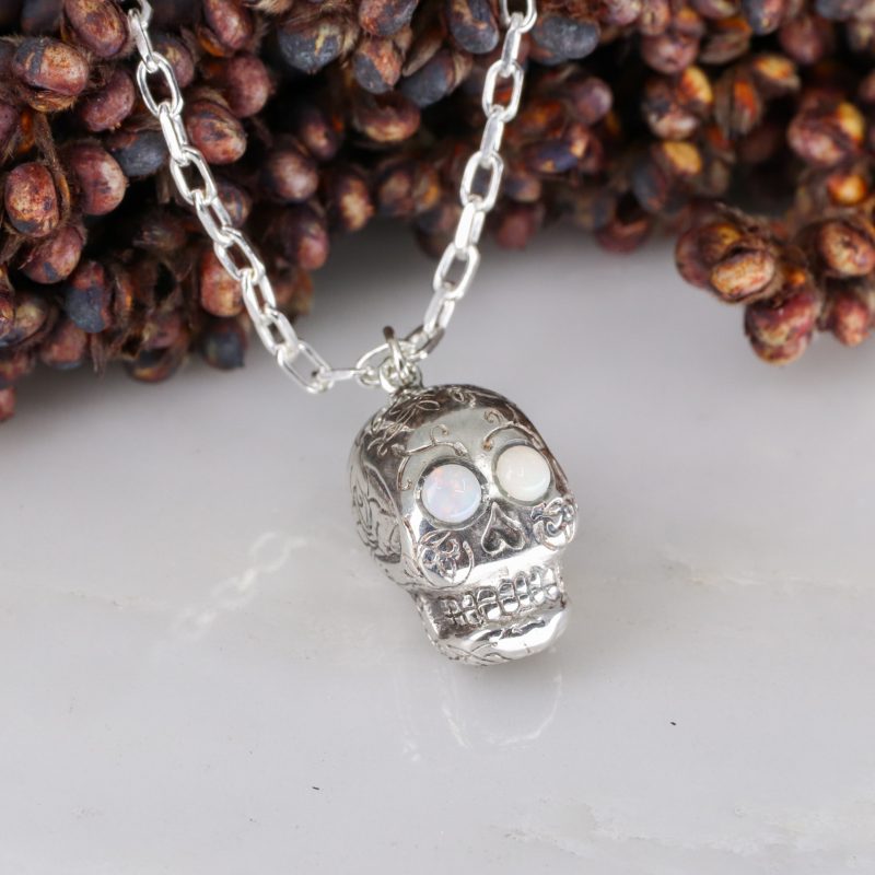 Silver sugar skull pendant set with opal eyes