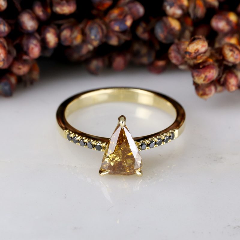 18ct yellow gold orange diamond rise ring with black diamond shoulders