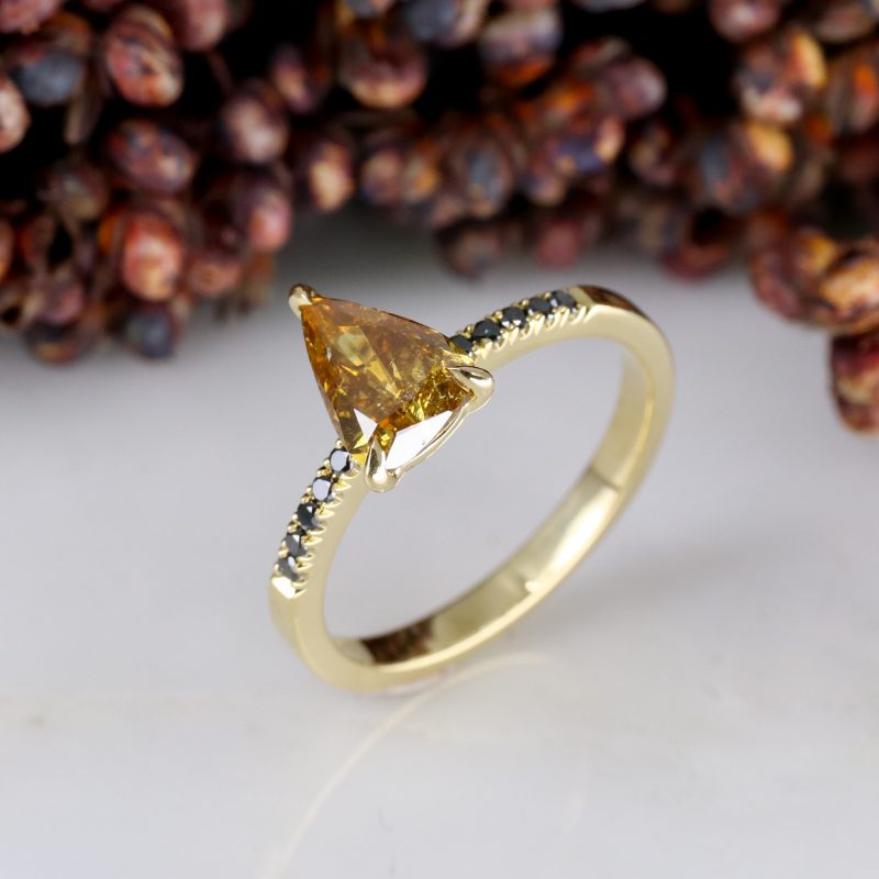 18ct yellow gold orange diamond rise ring with black diamond shoulders