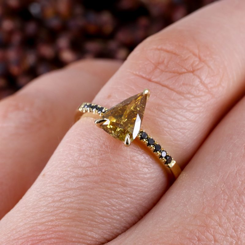 18ct yellow gold orange diamond rise ring with black diamond shoulders