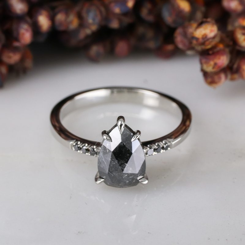 Platinum pear shape salt and pepper diamond with black diamond shoulders