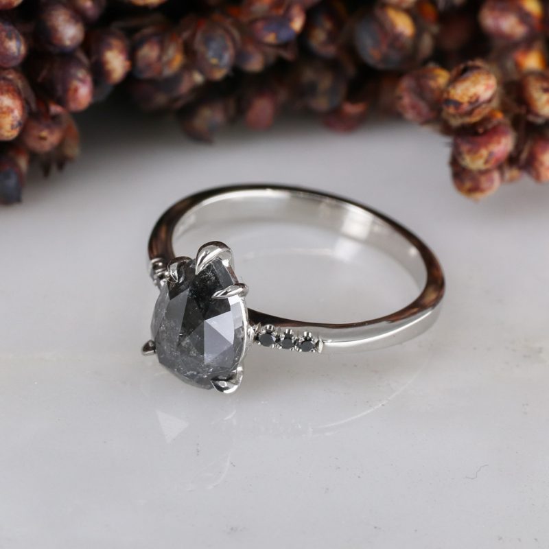 Platinum pear shape salt and pepper diamond with black diamond shoulders