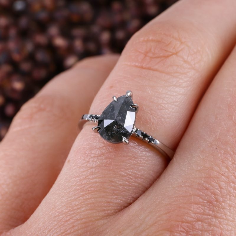 Platinum pear shape salt and pepper diamond with black diamond shoulders