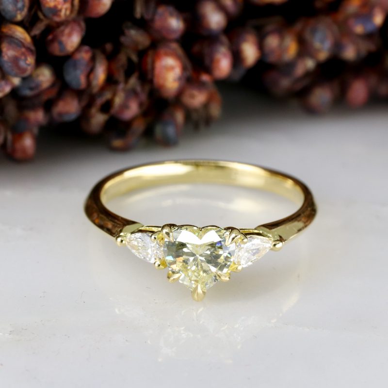 18ct yellow gold heart shape pale yellow diamond trilogy ring with white diamond pear shape shoulders