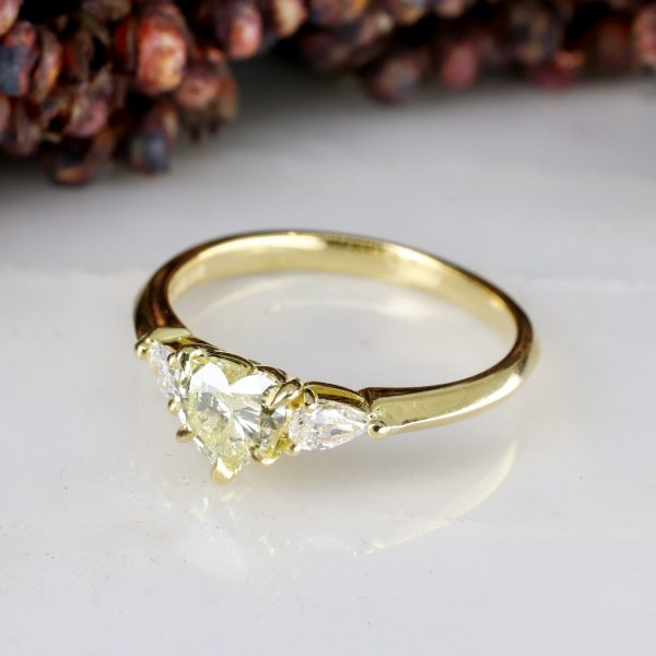 18ct yellow gold heart shape pale yellow diamond trilogy ring with white diamond pear shape shoulders