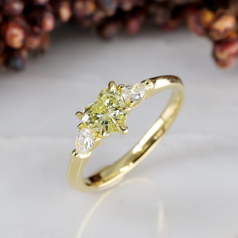 18ct yellow gold heart shape pale yellow diamond trilogy ring with white diamond pear shape shoulders