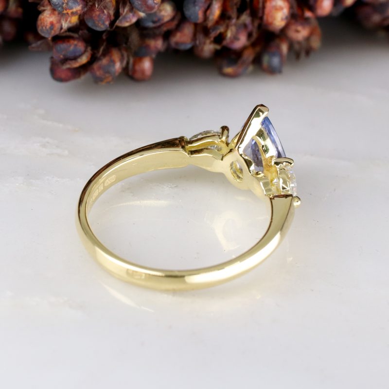 18ct yellow gold pear shape blue sapphire trilogy ring with pear shape salt and pepper diamond shoulders