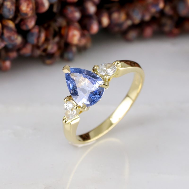 18ct yellow gold pear shape blue sapphire trilogy ring with pear shape salt and pepper diamond shoulders