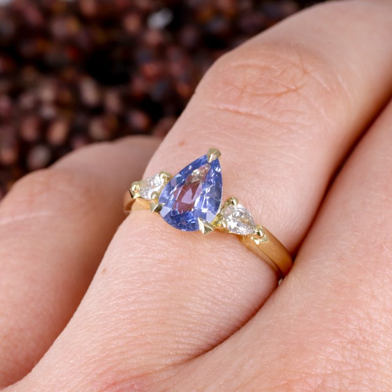 18ct yellow gold pear shape blue sapphire trilogy ring with pear shape salt and pepper diamond shoulders