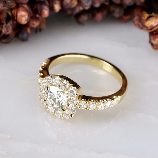18ct yellow gold cushion cut white diamond ring with diamond halo and shoulder detail