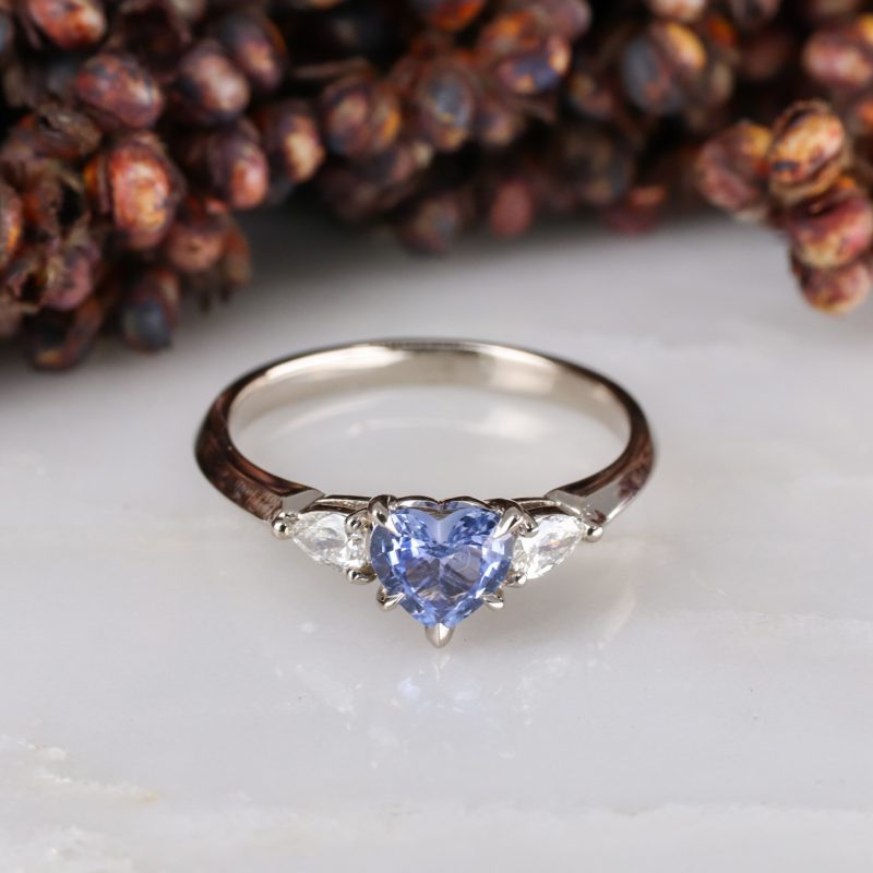 18ct white gold heart shape blue sapphire trilogy ring with white diamond pear shape shoulders