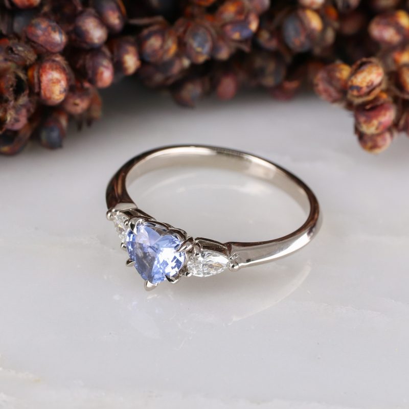 18ct white gold heart shape blue sapphire trilogy ring with white diamond pear shape shoulders