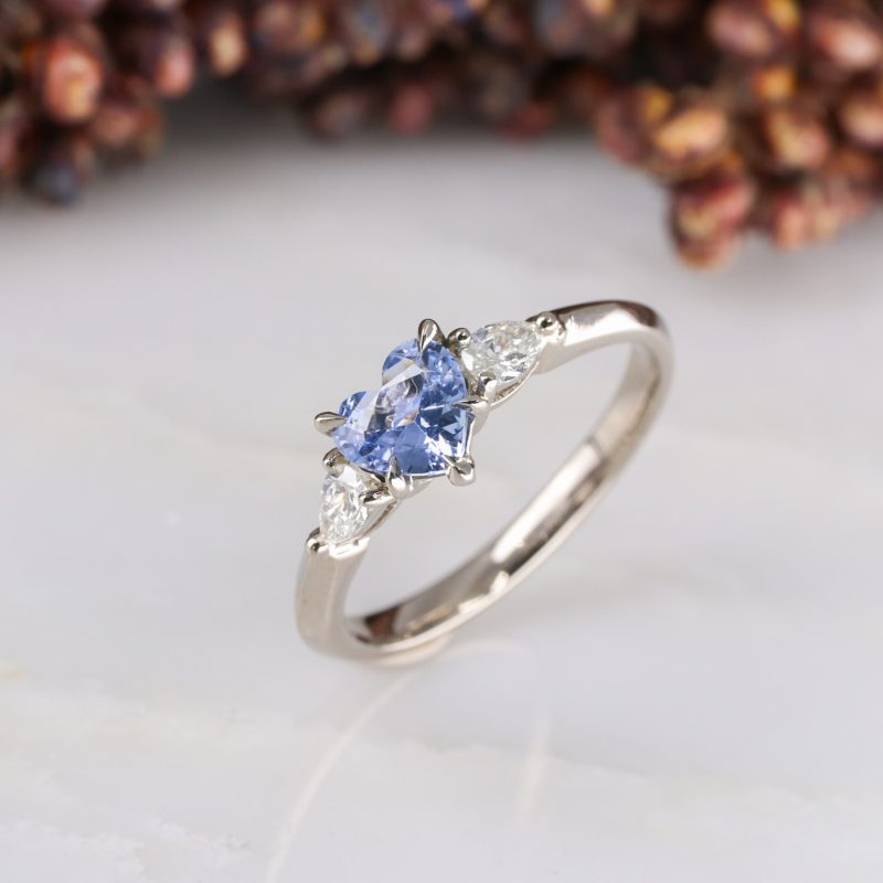 18ct white gold heart shape blue sapphire trilogy ring with white diamond pear shape shoulders