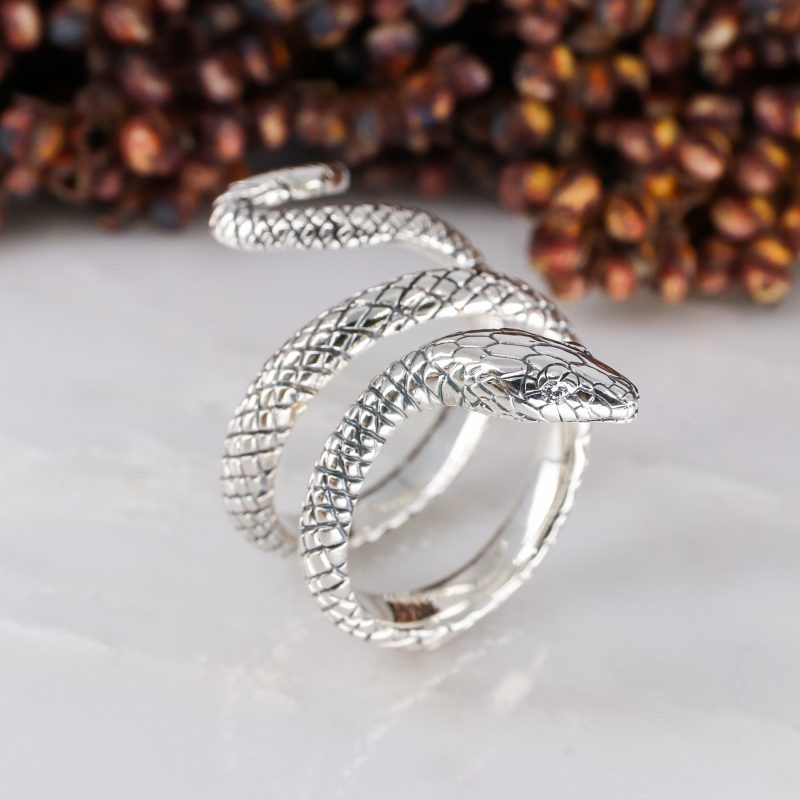 Silver coiled snake ring with white diamond eyes