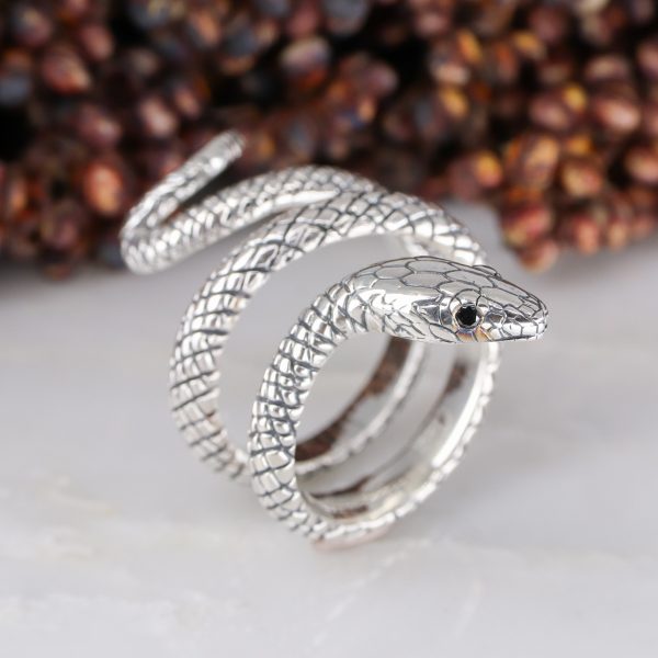 Silver coiled snake ring with black diamond eyes
