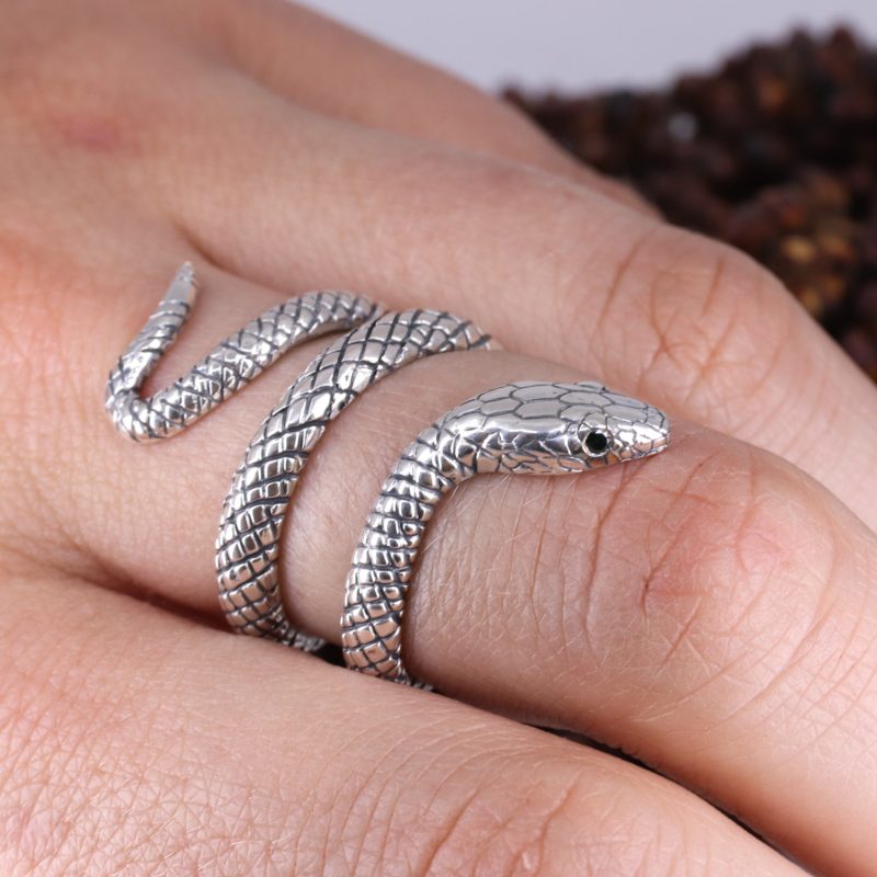 Silver coiled snake ring with black diamond eyes
