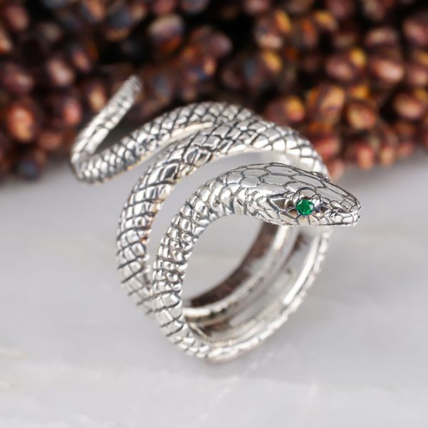 Silver coiled snake ring with emerald eyes