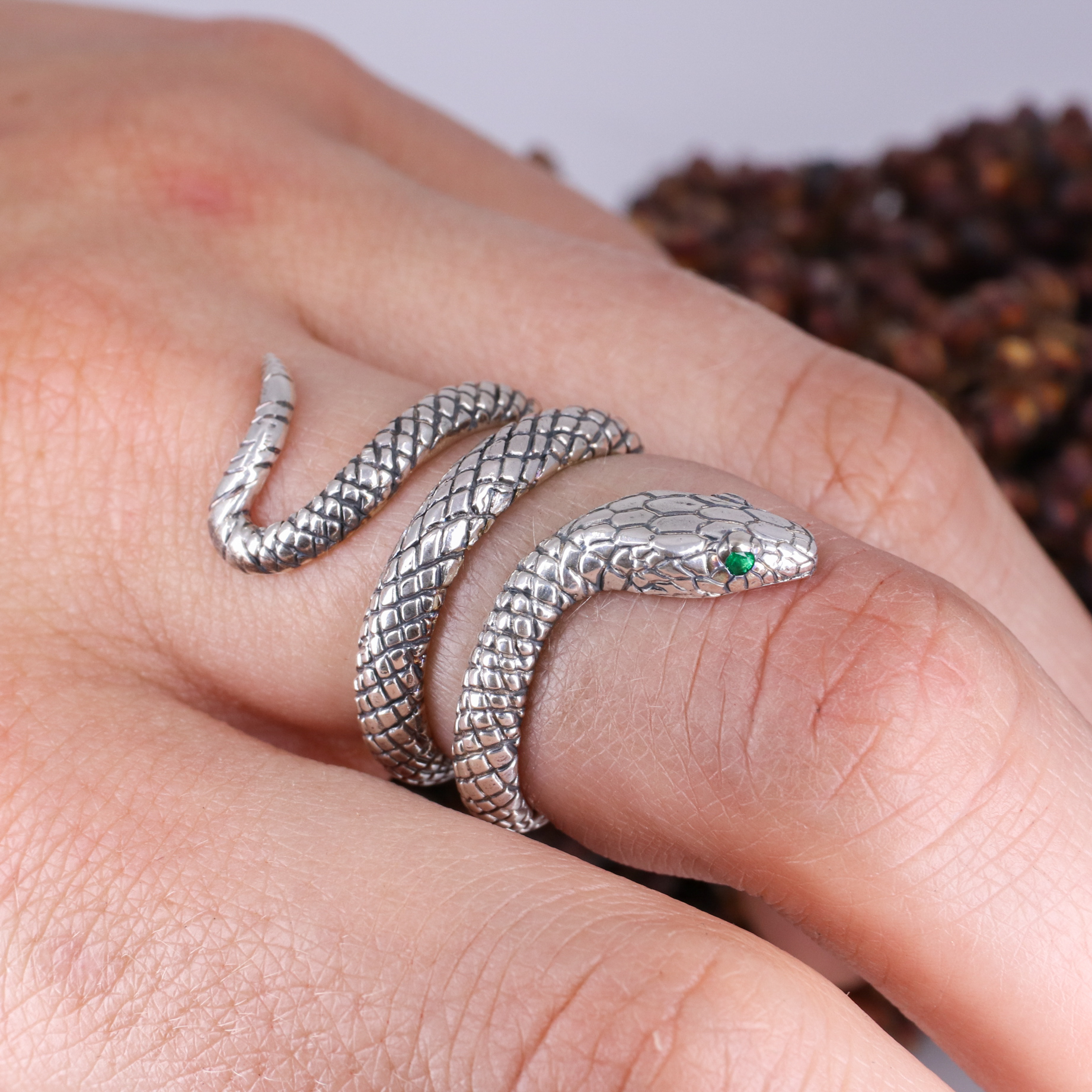 Silver coiled snake ring with emerald eyes Baroque Jewellery