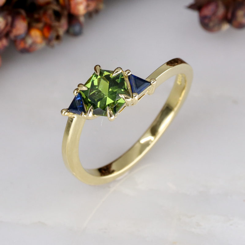 18ct yellow gold twist trilogy ring with green and blue sapphires