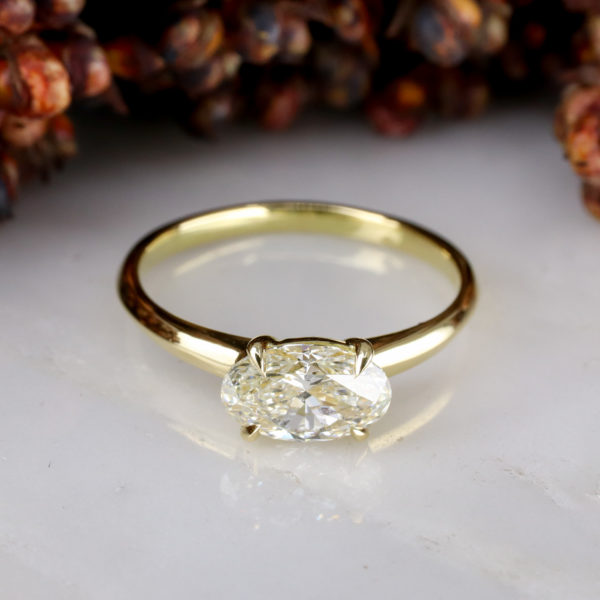 18ct yellow gold east-west engagement ring with pale yellow diamond