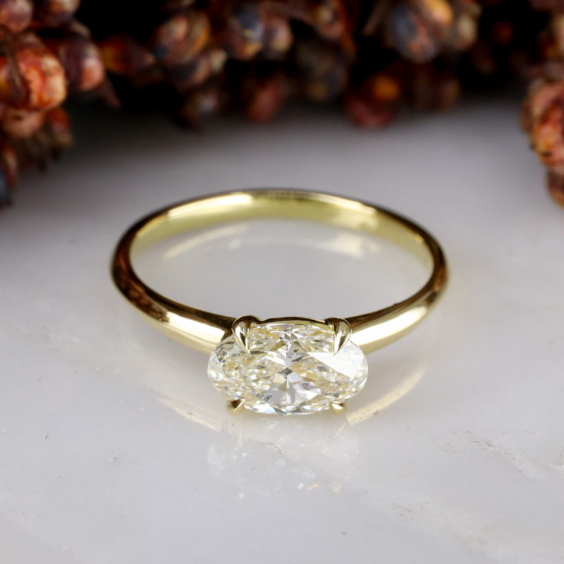 18ct yellow gold east-west engagement ring with pale yellow diamond