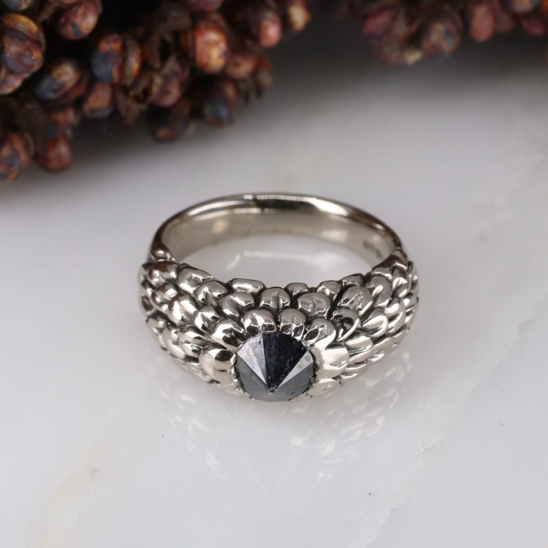 18ct white gold feathered ring with up-side-down set black diamond