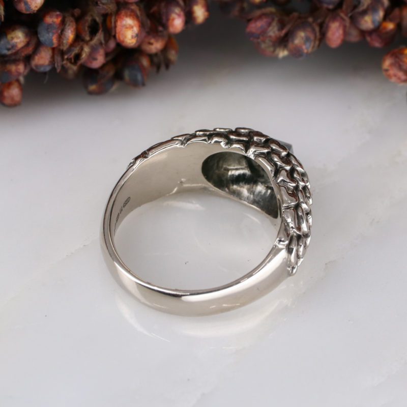 18ct white gold feathered ring with up-side-down set black diamond