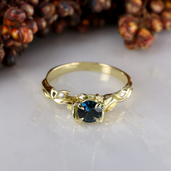 18ct yellow gold Rose and Thorn engagement ring with teal sapphire