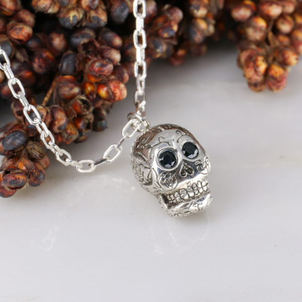 Silver sugar skull pendant set with black diamond eyes