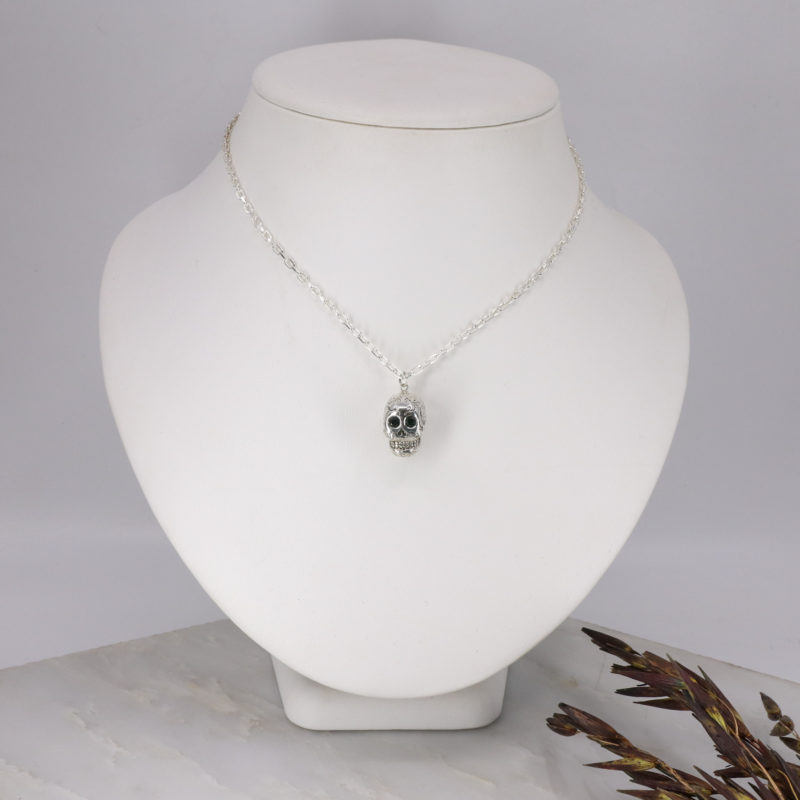 Silver sugar skull pendant set with black diamond eyes