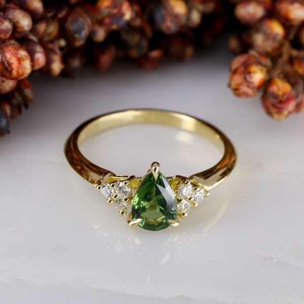18ct yellow gold mini coco cluster ring with pear shaped green sapphire